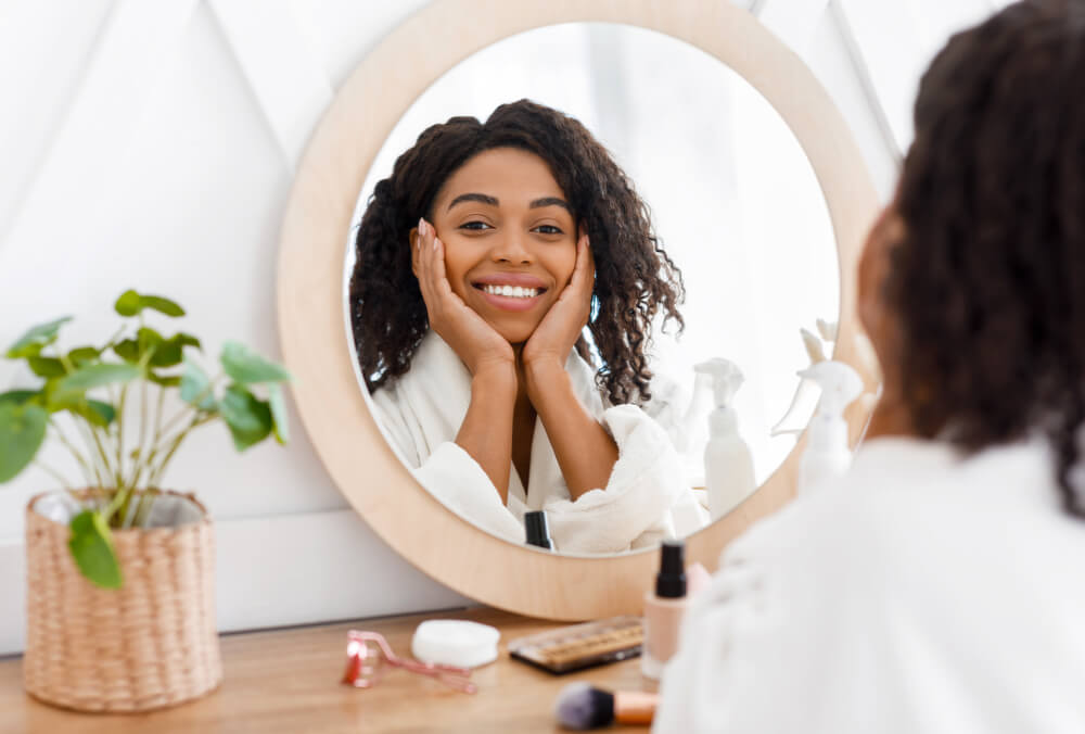 Smiling woman looking in a mirror